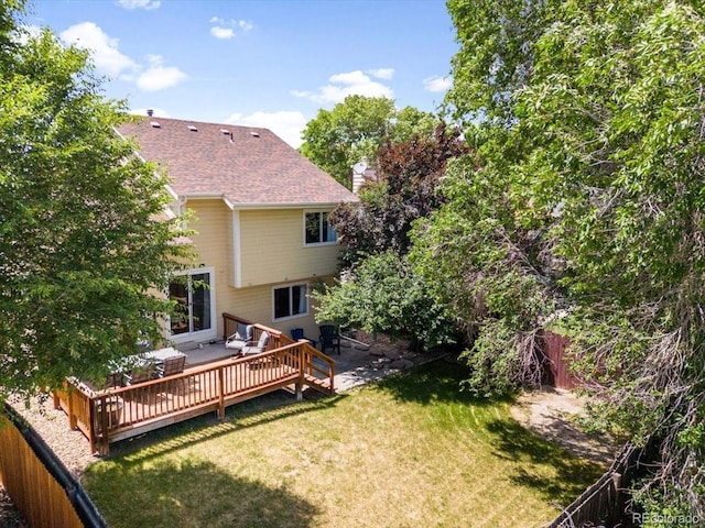 6318 Newton Ct, Arvada, CO 80003 - back of property with a fenced backyard, a chimney, a deck, and roof with shingles