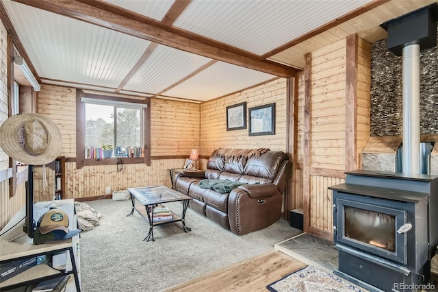 34502 Chilton Ave, Pine, CO 80470 - living room with beamed ceiling, wood finished floors, a wood stove, and wooden walls
