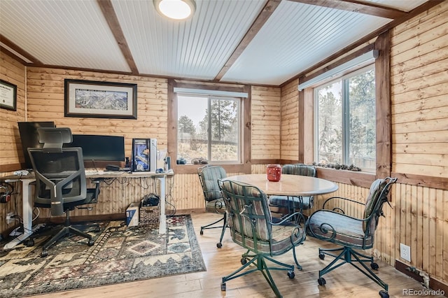 34502 Chilton Ave, Pine, CO 80470 - dining space with wood walls, a wealth of natural light, beamed ceiling, and wood finished floors
