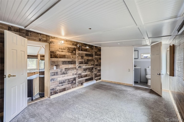 34502 Chilton Ave, Pine, CO 80470 - carpeted spare room with wooden walls, baseboards, and a wealth of natural light