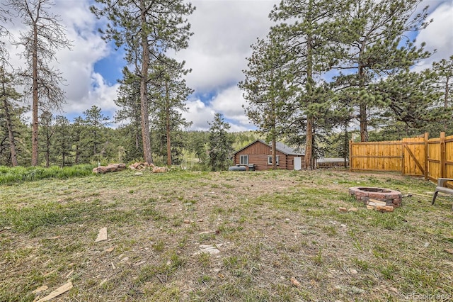 34502 Chilton Ave, Pine, CO 80470 - view of yard with an outdoor fire pit and fence