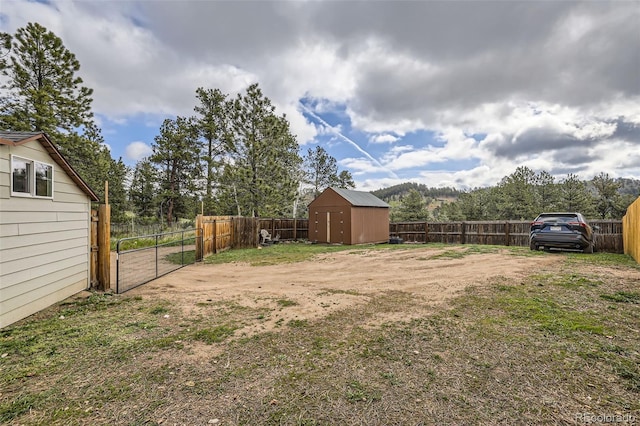 34502 Chilton Ave, Pine, CO 80470 - view of yard with a fenced backyard, an outdoor structure, and a storage unit