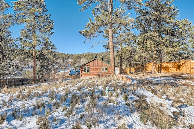 34502 Chilton Ave, Pine, CO 80470 - snow covered rear of property with log exterior and fence