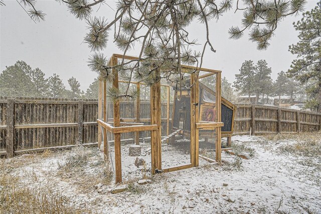 34502 Chilton Ave, Pine, CO 80470 - snow covered playground with an outbuilding, a fenced backyard, and exterior structure