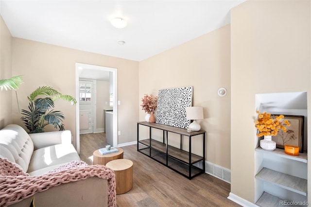 sitting room with hardwood / wood-style flooring