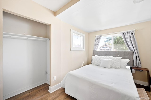 bedroom with wood-type flooring and a closet