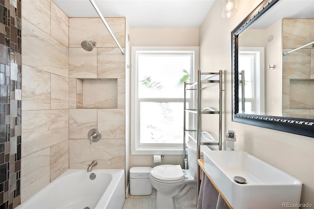 full bathroom featuring tile patterned floors, toilet, sink, and tiled shower / bath