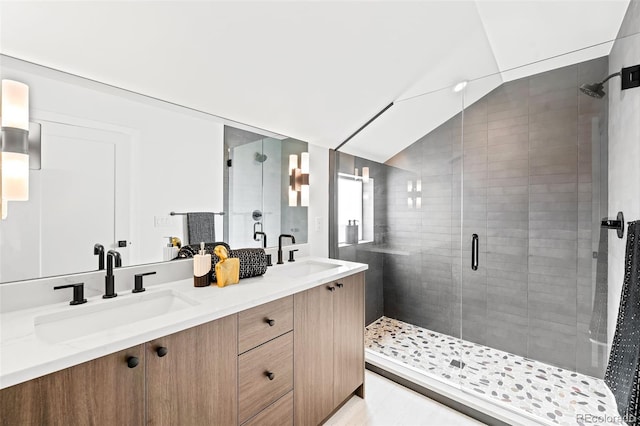 bathroom featuring walk in shower, lofted ceiling, and vanity