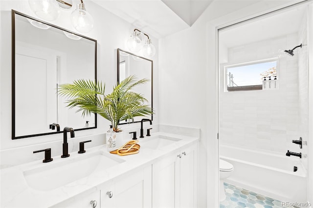 full bathroom with toilet, vanity, and tiled shower / bath combo