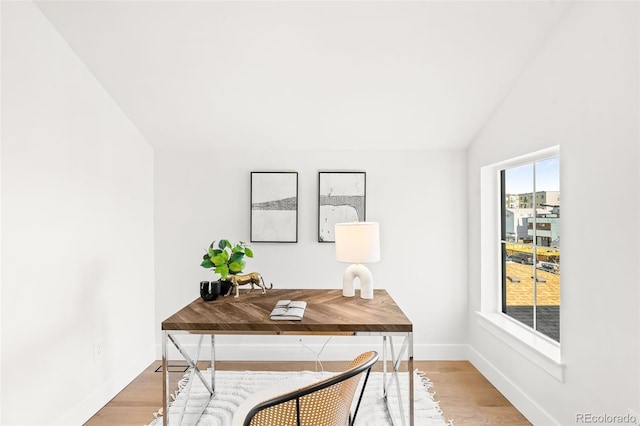 office space with vaulted ceiling and wood-type flooring