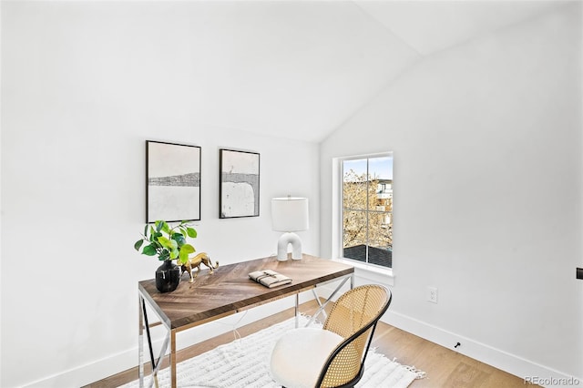 office featuring hardwood / wood-style flooring and high vaulted ceiling