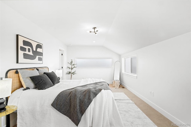 carpeted bedroom featuring lofted ceiling