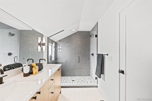 bathroom featuring walk in shower and vanity