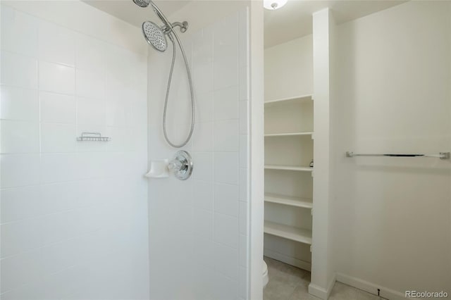 full bathroom featuring tile patterned flooring and a tile shower