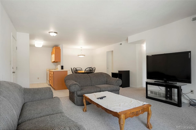 living room featuring visible vents and light colored carpet