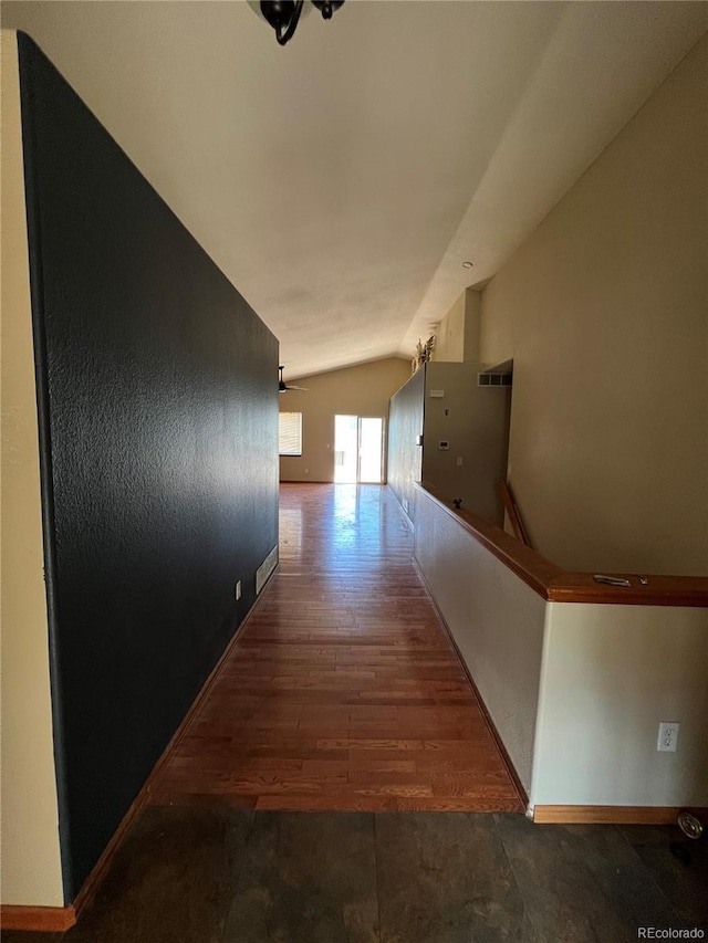 hallway with lofted ceiling and wood-type flooring