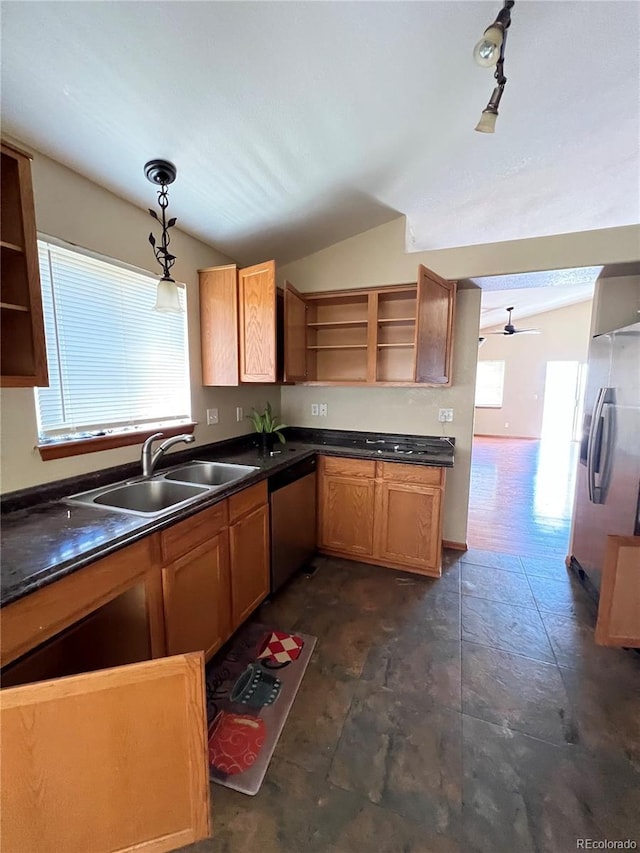 kitchen featuring pendant lighting, sink, vaulted ceiling, ceiling fan, and appliances with stainless steel finishes