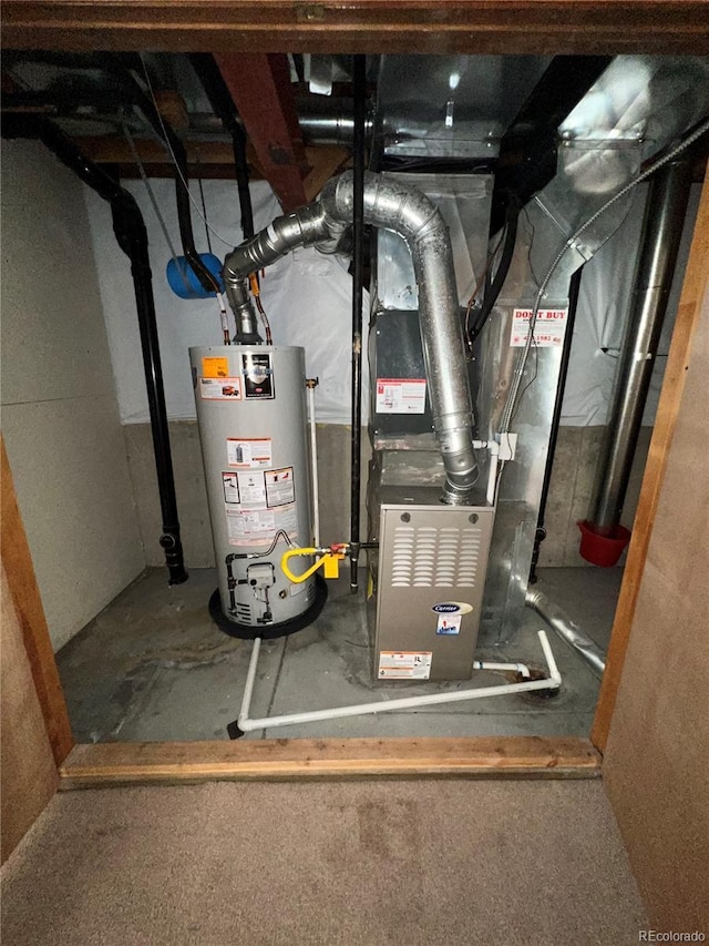 utility room with heating unit and water heater