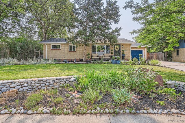 single story home featuring a front yard and a garage