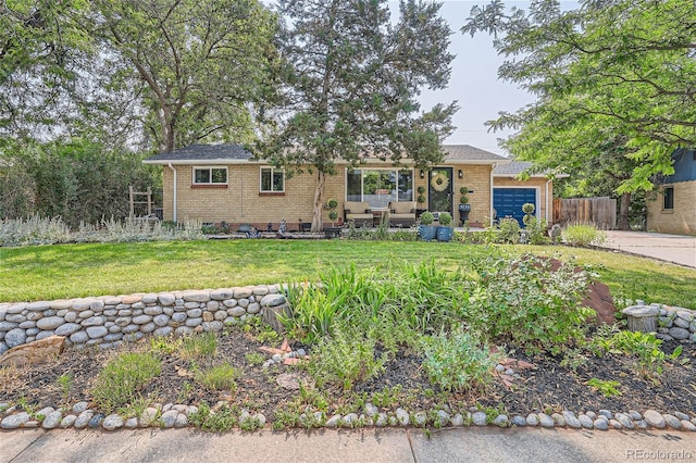 ranch-style house featuring a garage and a front yard