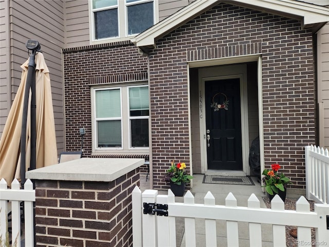 15503 W 65th Ave Unit C, Arvada, CO 80007 - view of exterior entry featuring brick siding and a gate