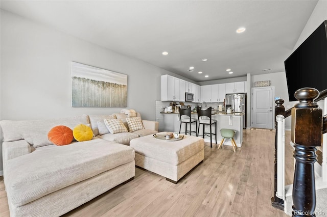 15503 W 65th Ave Unit C, Arvada, CO 80007 - living room with light wood finished floors and recessed lighting