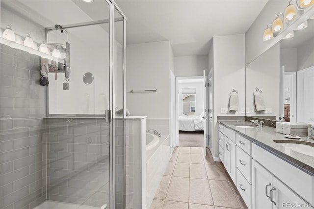 15503 W 65th Ave Unit C, Arvada, CO 80007 - full bath with double vanity, connected bathroom, a stall shower, a garden tub, and tile patterned floors