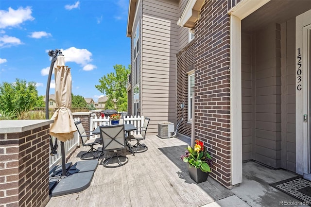 15503 W 65th Ave Unit C, Arvada, CO 80007 - view of patio / terrace featuring outdoor dining area and a wooden deck