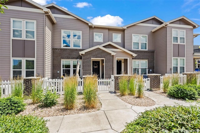 15503 W 65th Ave Unit C, Arvada, CO 80007 - view of property with a fenced front yard, a gate, and brick siding