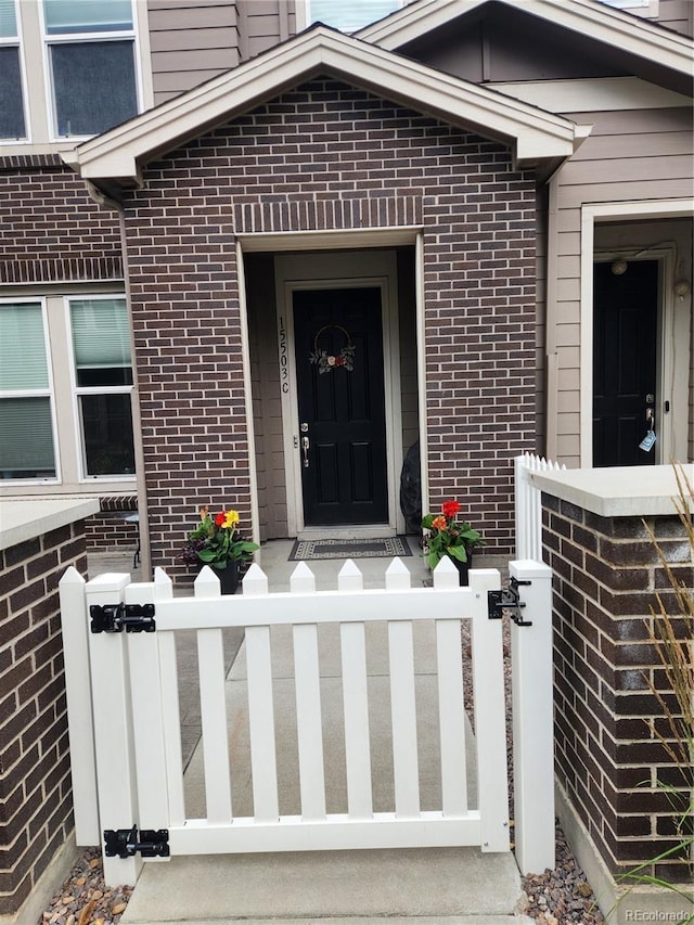 15503 W 65th Ave Unit C, Arvada, CO 80007 - view of exterior entry with brick siding and a gate