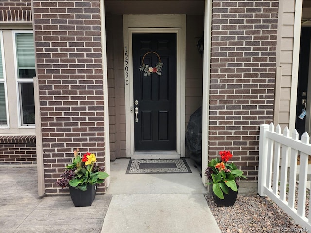 15503 W 65th Ave Unit C, Arvada, CO 80007 - doorway to property featuring brick siding