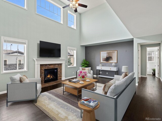 10730 Hillrose St, Parker, CO 80134 - living area featuring baseboards, wood finished floors, a fireplace, a high ceiling, and ceiling fan