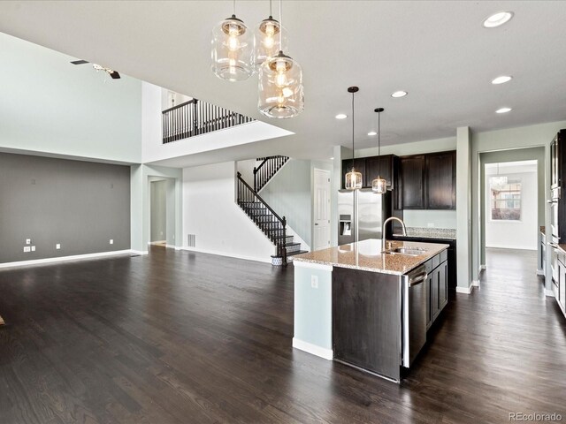 10730 Hillrose St, Parker, CO 80134 - kitchen featuring stainless steel appliances, a sink, a chandelier, recessed lighting, and dark brown cabinetry