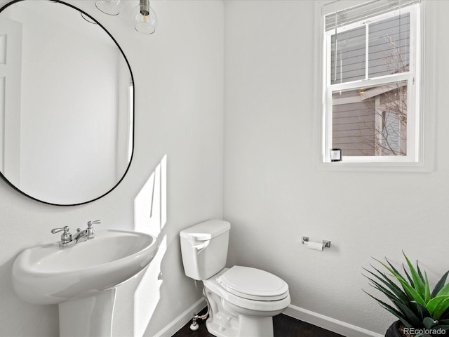 10730 Hillrose St, Parker, CO 80134 - bathroom featuring baseboards, toilet, and a sink
