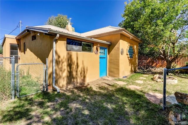 rear view of property with a yard