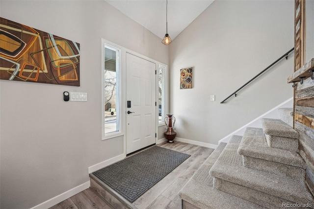 entrance foyer featuring lofted ceiling and light hardwood / wood-style floors