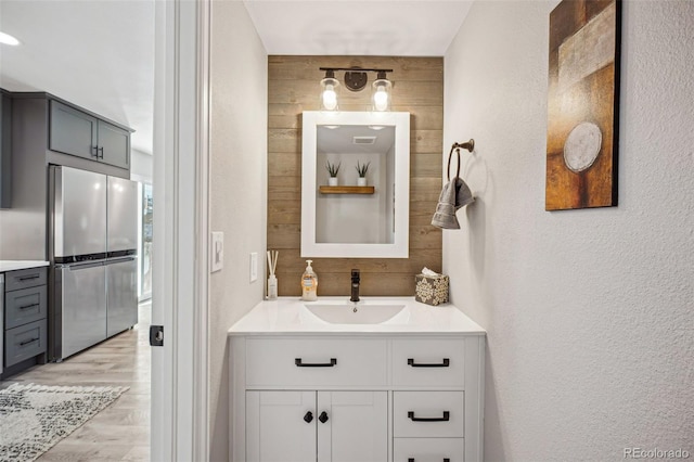 bathroom with vanity and hardwood / wood-style flooring