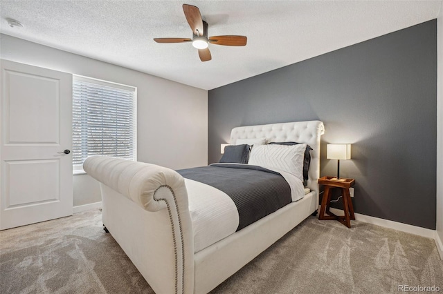 bedroom with light carpet, a textured ceiling, and ceiling fan