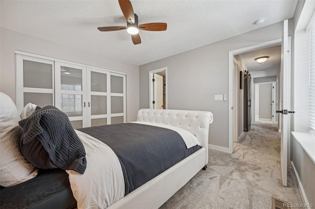 bedroom featuring light carpet, a textured ceiling, french doors, and ceiling fan