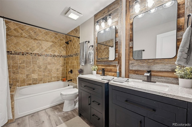 full bathroom featuring shower / bath combination with curtain, vanity, toilet, and hardwood / wood-style floors