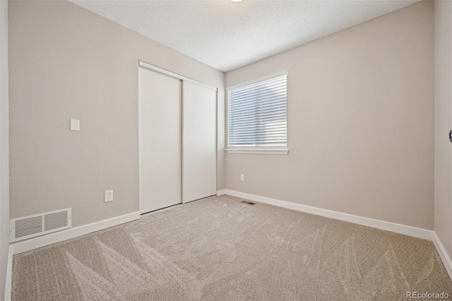 unfurnished bedroom featuring a closet and carpet