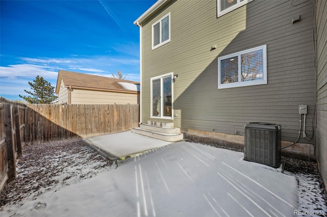 snow covered patio featuring central AC