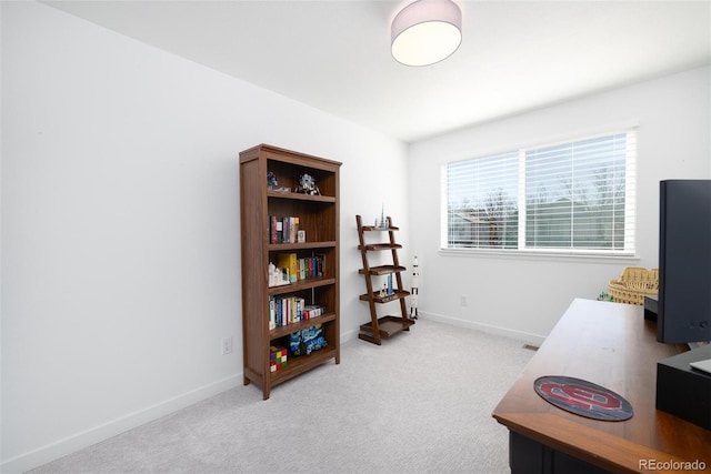 office space with light carpet and baseboards