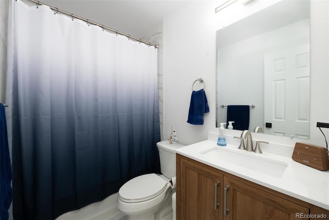 bathroom featuring toilet, curtained shower, and vanity