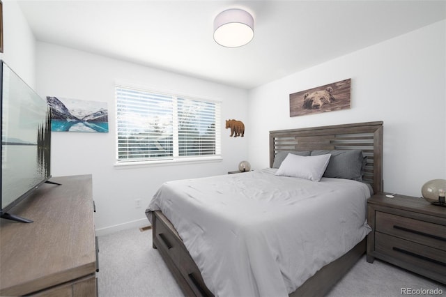 carpeted bedroom featuring baseboards