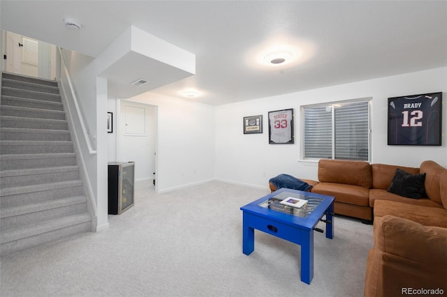 carpeted living room with stairway, visible vents, and baseboards