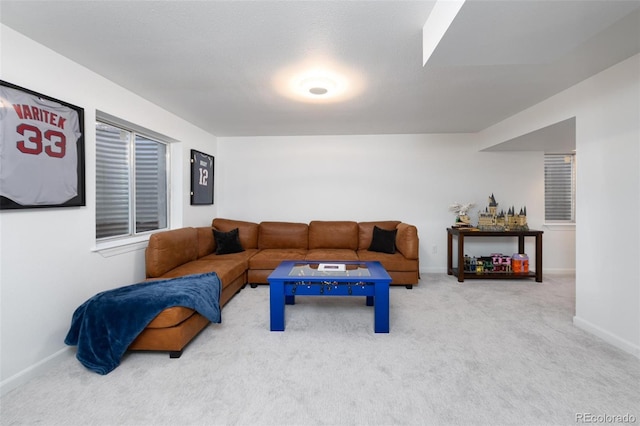 carpeted living area with baseboards