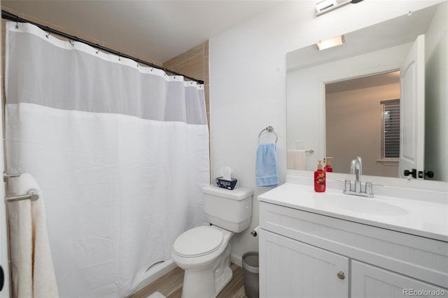 full bathroom with toilet, a shower with curtain, wood finished floors, and vanity