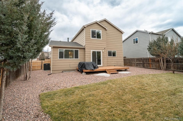 back of property with a yard, a fenced backyard, a wooden deck, and central air condition unit