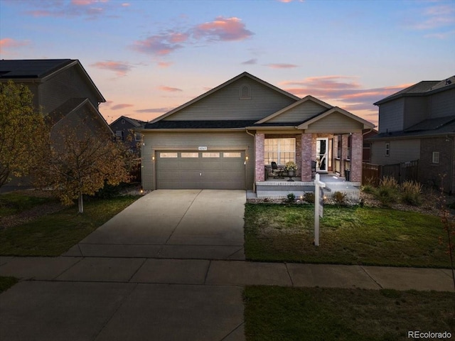 view of front of house with driveway, a front yard, and a garage